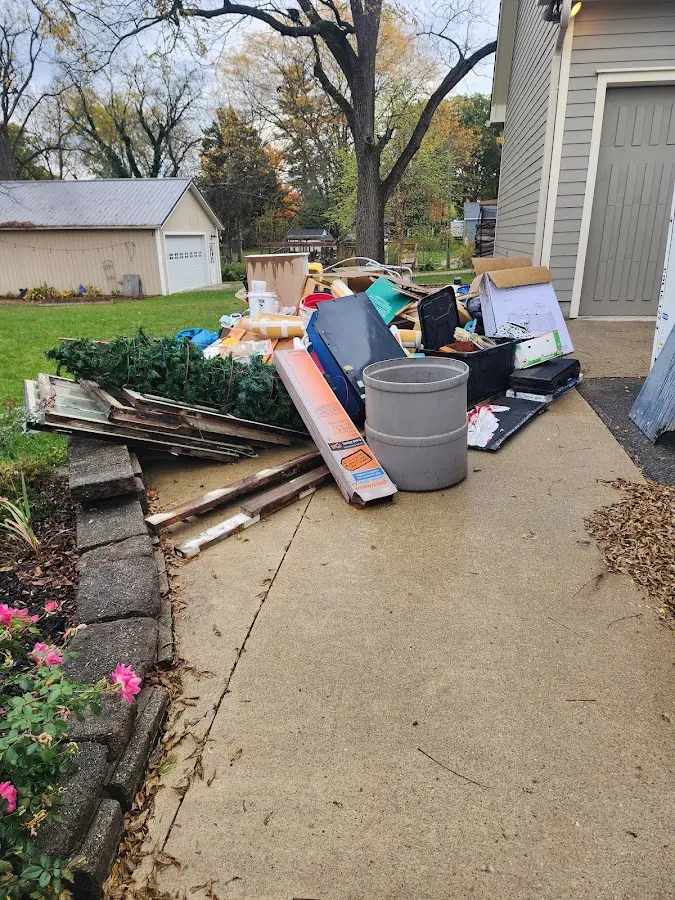 Dumpster being loaded with debris for Roofing Dumpster Rental in Londonderry